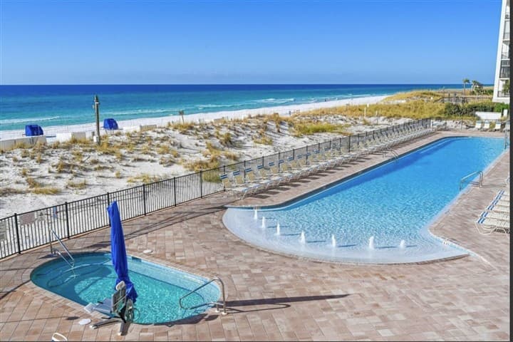 Gulf pool and hot tub beside the beach at Pelican Beach Resort