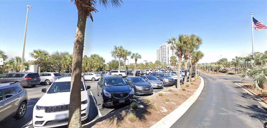 Open surface parking area at Pelican Beach Resort