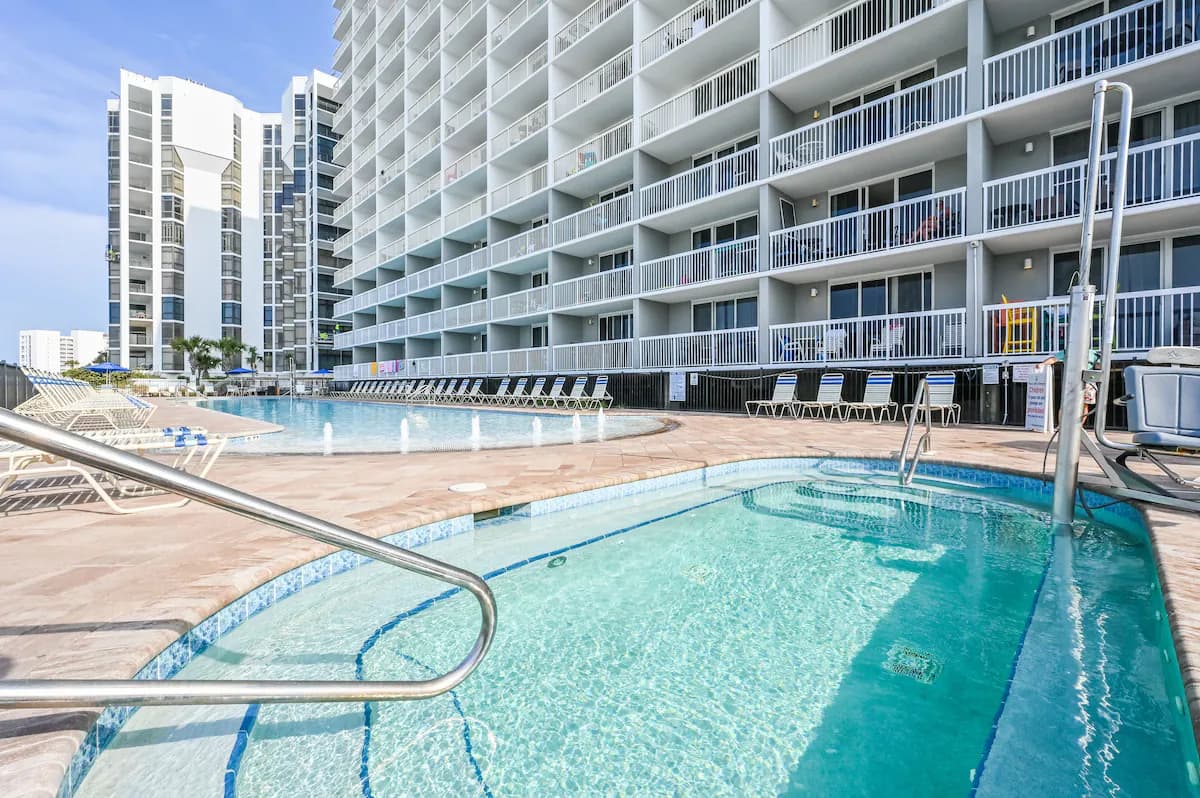 Outdoor pool and hot tub at Pelican Beach Resort